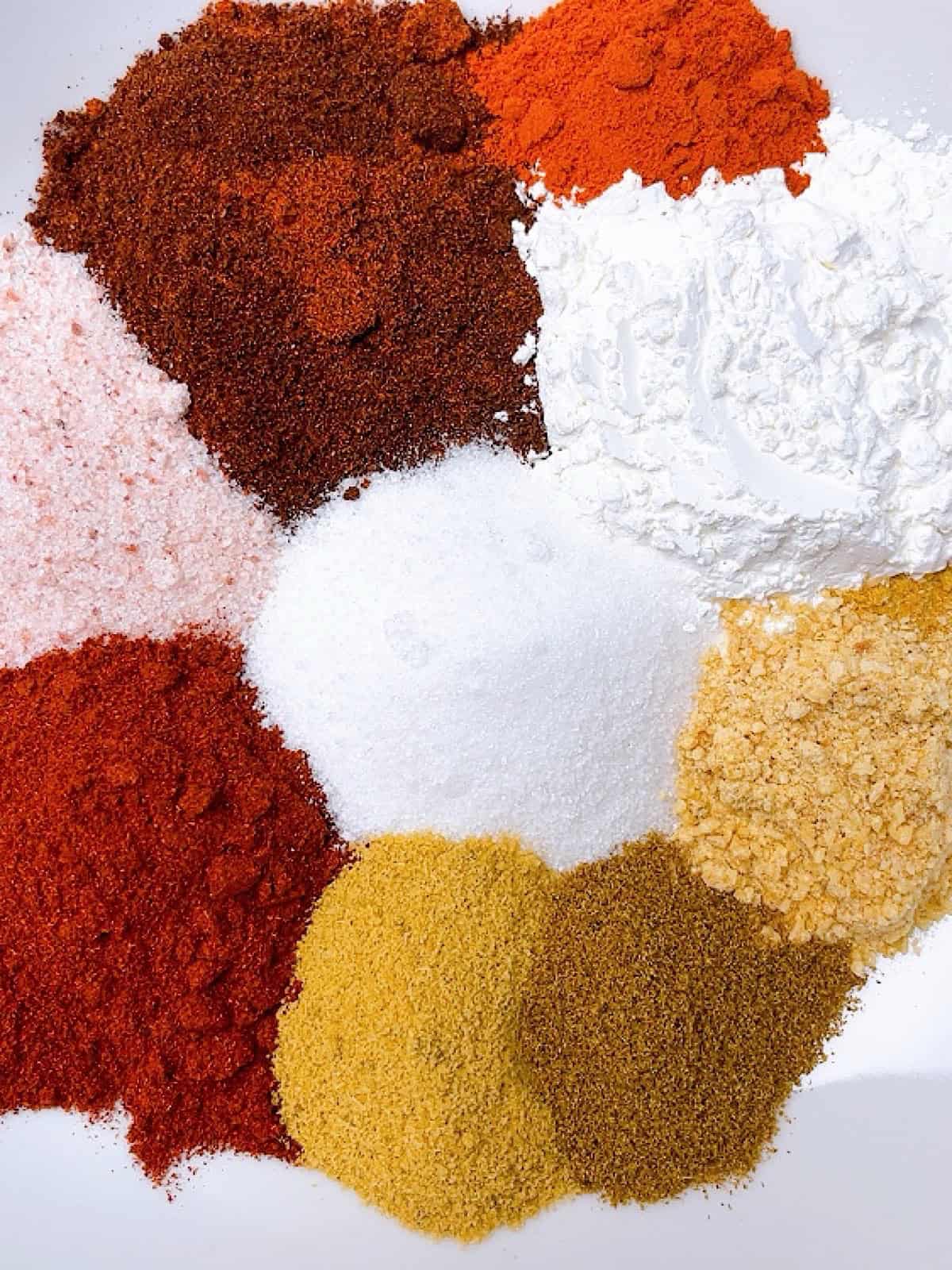 Fajita seasoning spice mix arranged on a plate to show color variation.