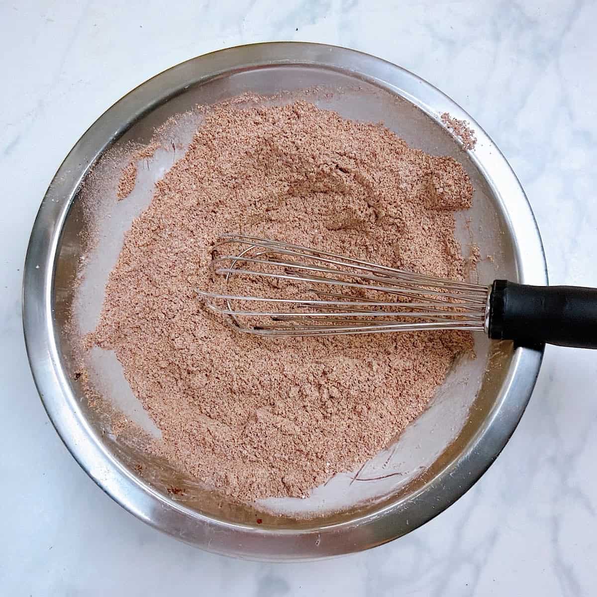 Whisking the fajita spice blend in a small mixing bowl.