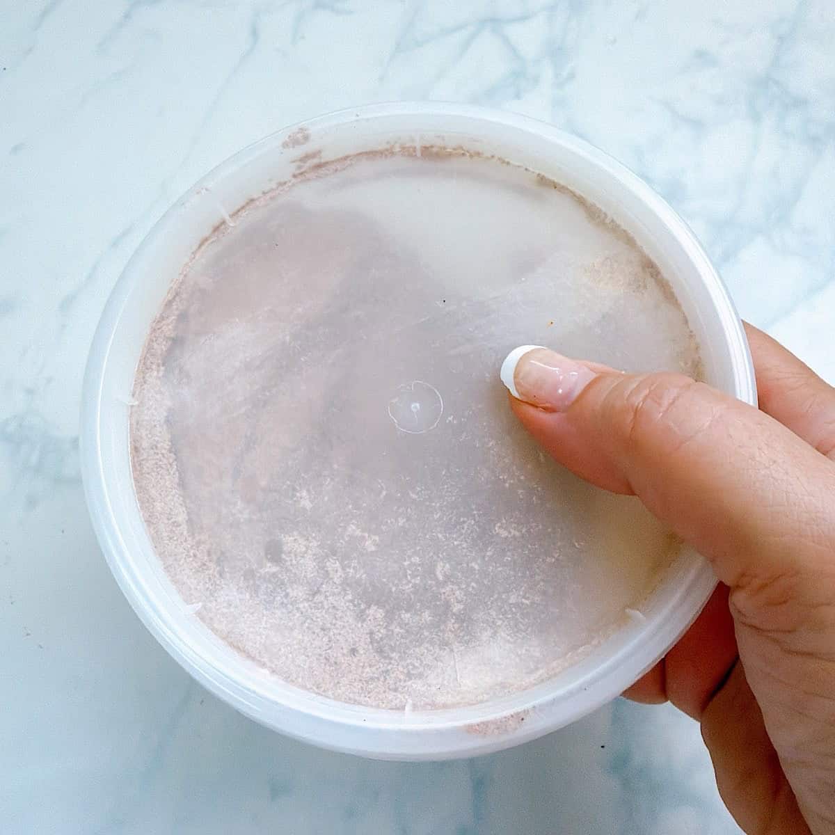 Fajita seasoning in a storage container with lid.