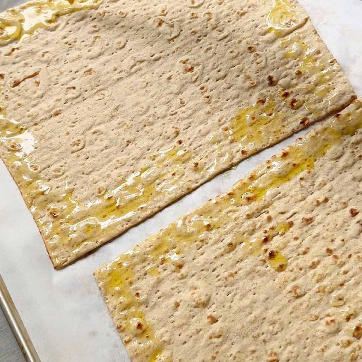 Oil brushed lightly around the edges of each lavash bread.