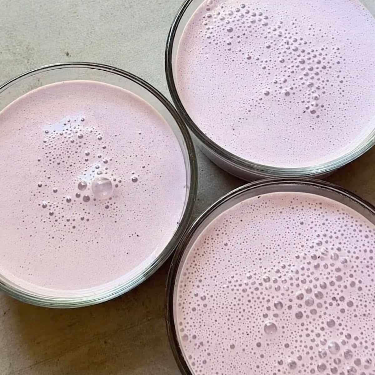 Glass containers with blueberry mixture and room for toppings.