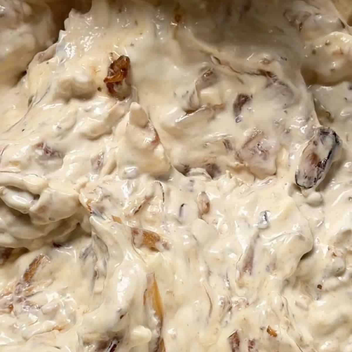 Caramelized onion dip fully mixed and ready to chill.