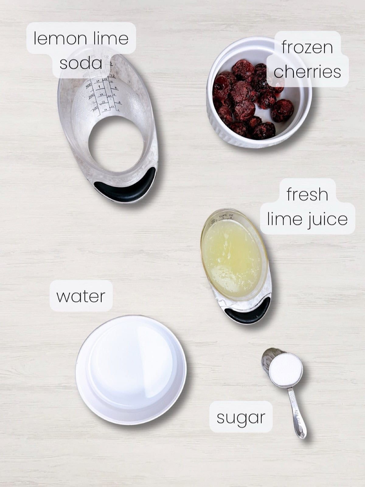 A labeled image of everything needed to make a cherry limeade recipe.
