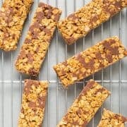 Rectangular chewy peanut butter granola bars on a wire rack.