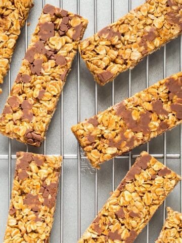 Rectangular chewy peanut butter granola bars on a wire rack.