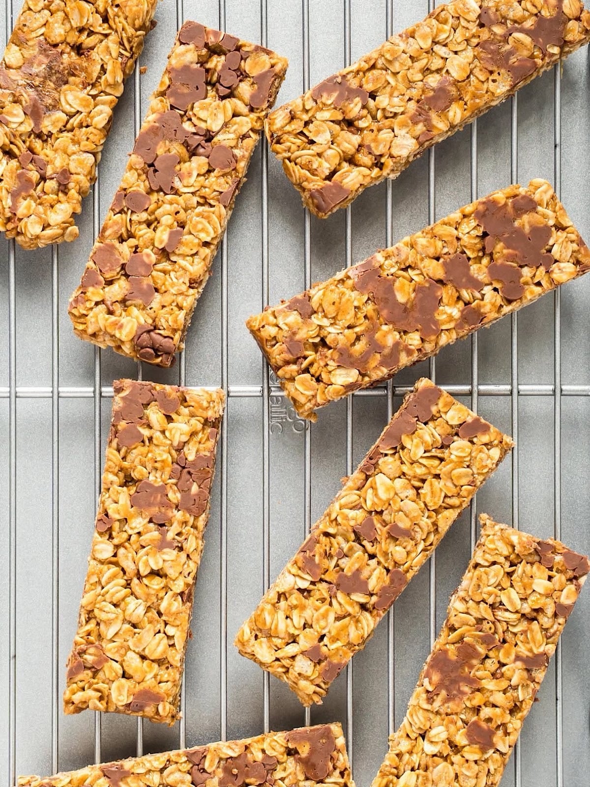 Rectangular chewy peanut butter granola bars on a wire rack.