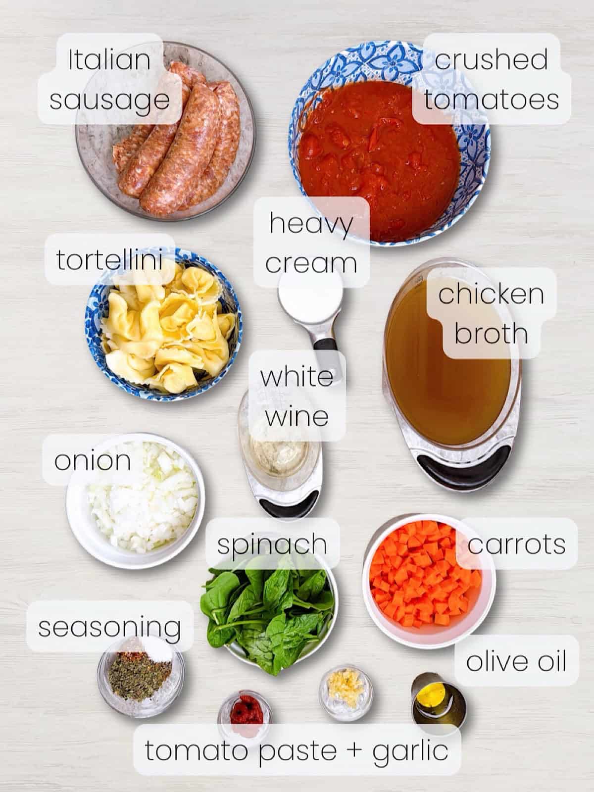A labeled image of everything needed to make a Creamy Tuscan tortellini soup.