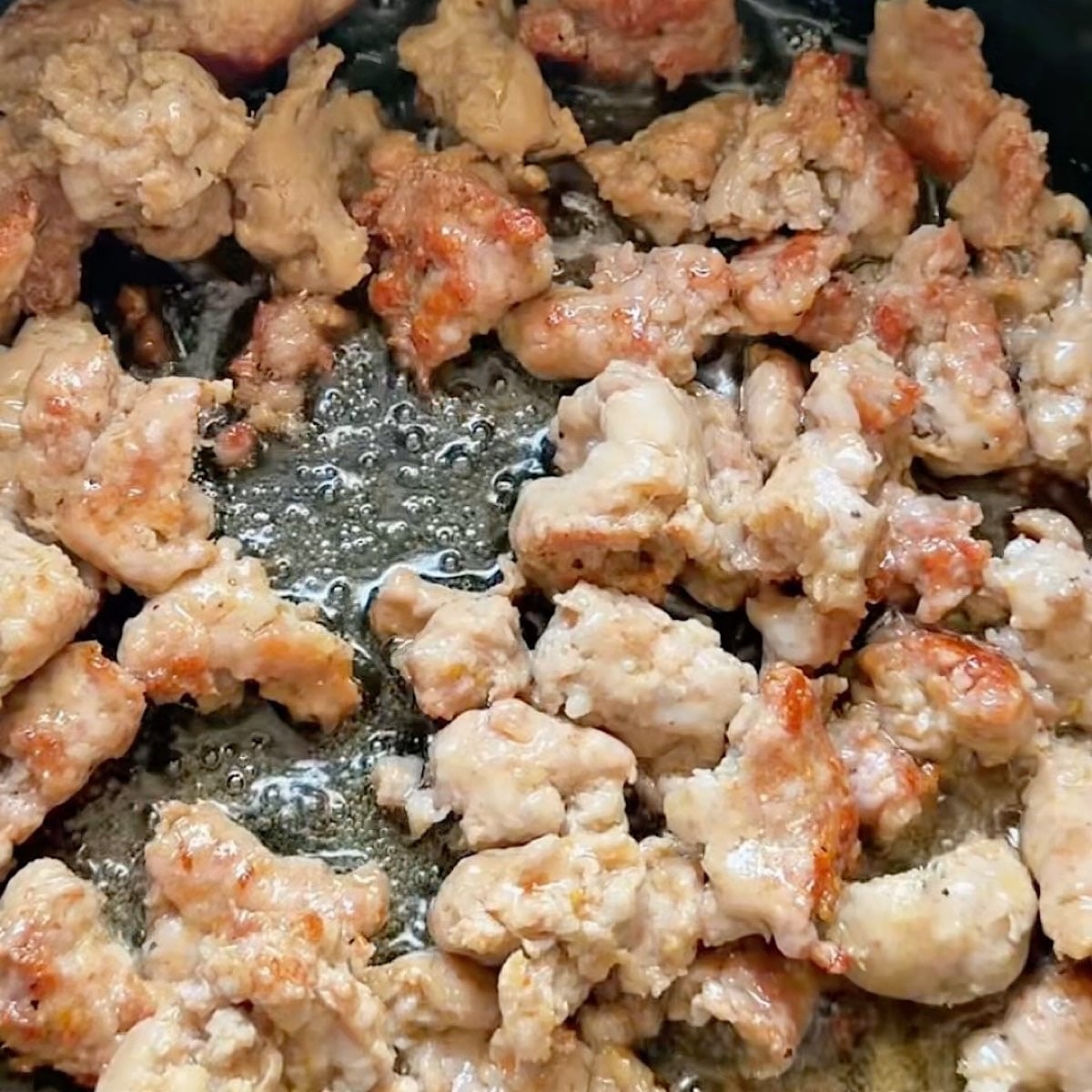 Browning the Italian sausage chunks in a dutch oven.