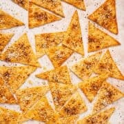 Crispy Mediterranean lavash crackers with za'atar on a sheet pan.