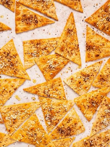 Crispy Mediterranean lavash crackers with za'atar on a sheet pan.