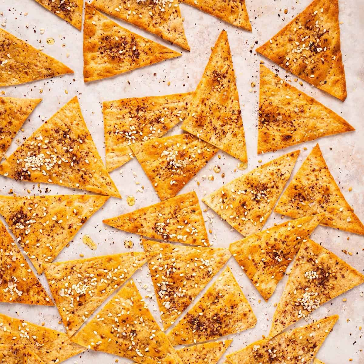 Crispy Mediterranean lavash crackers with za'atar on a sheet pan.