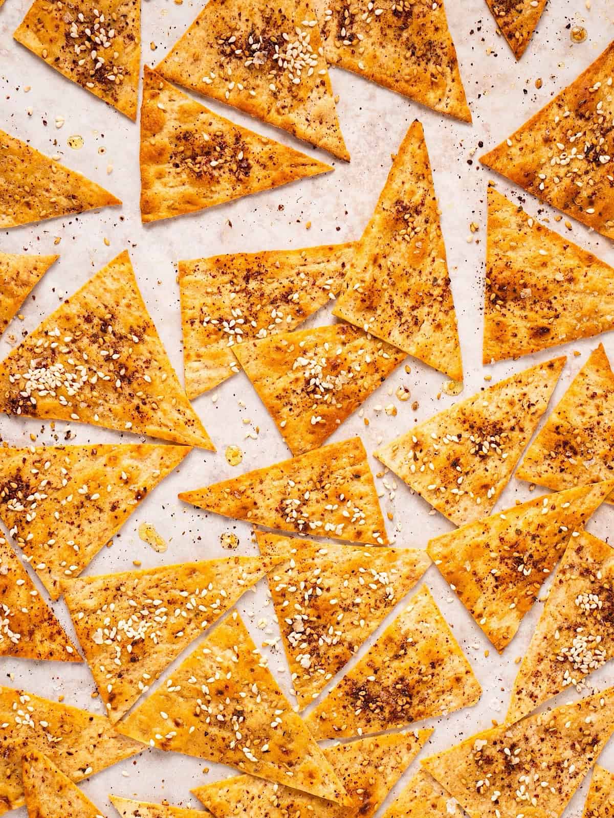 Crispy Mediterranean lavash crackers with za'atar on a sheet pan.