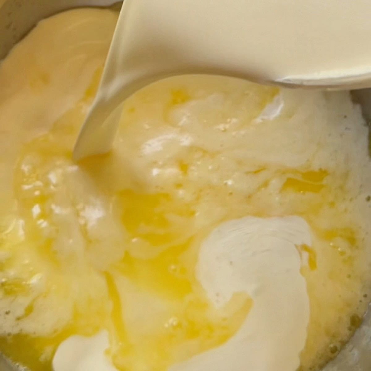 Adding heavy cream to the butter.
