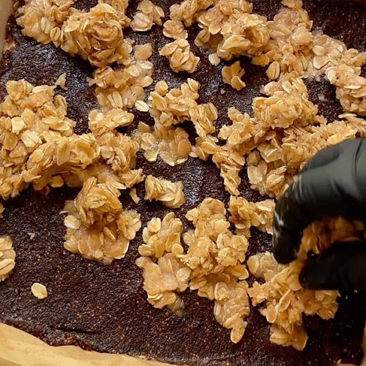Adding the crumb topping to the top of the fig puree.