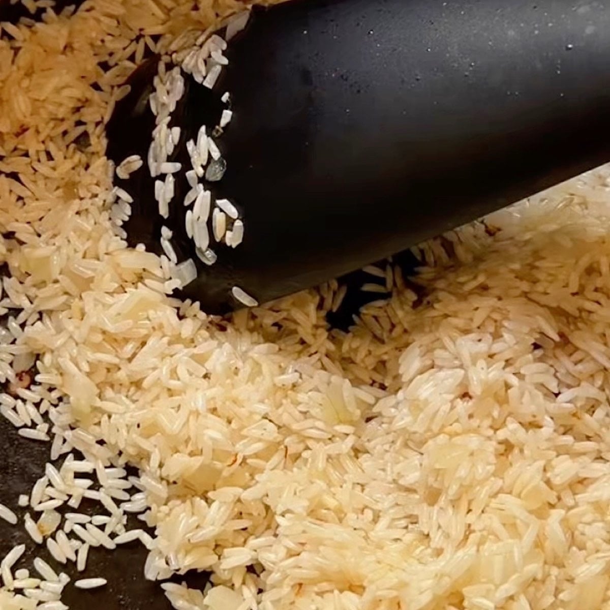 Toasting the rice with the translucent onion.
