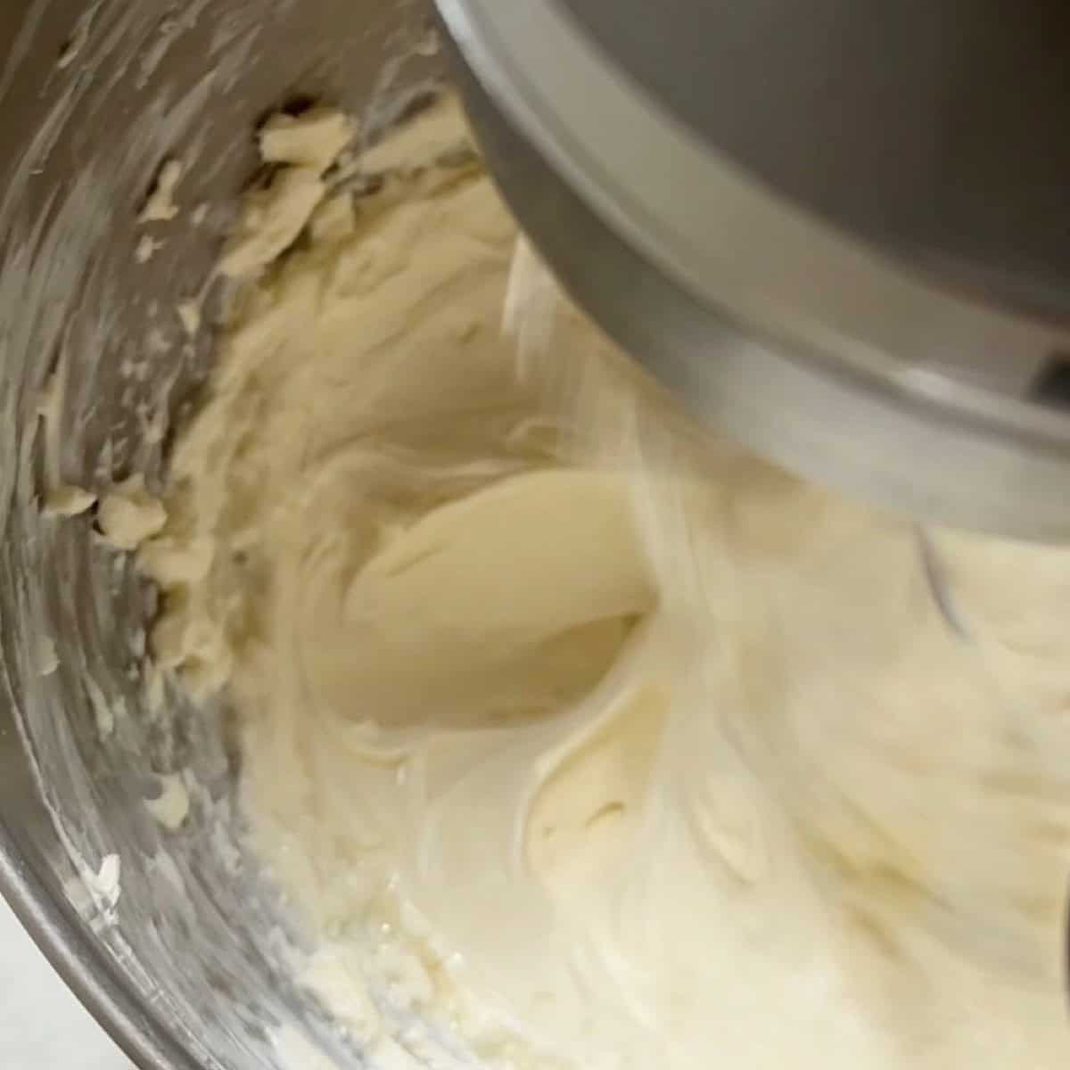 Whipped cream cheese in a stand mixer.