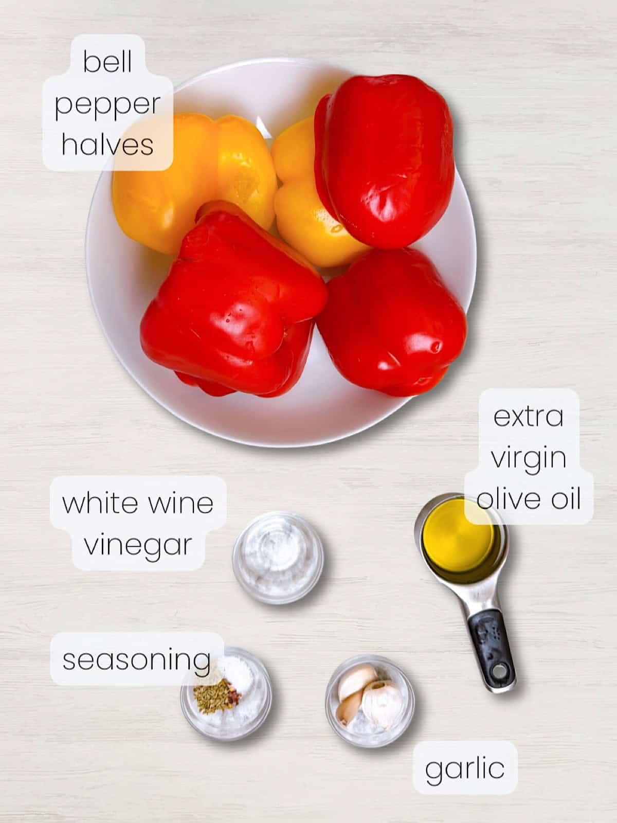 A labeled image of all ingredients needed to make Italian roasted peppers with garlic and olive oil.