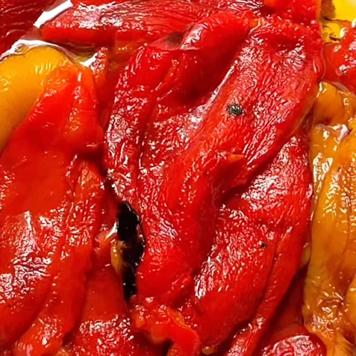 Italian roasted peppers marinating in olive oil and garlic.