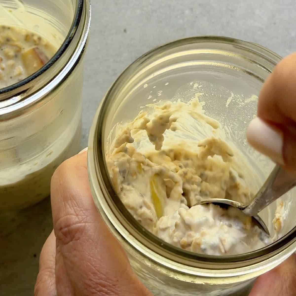 Showing consistency of chilled oats with a spoon.