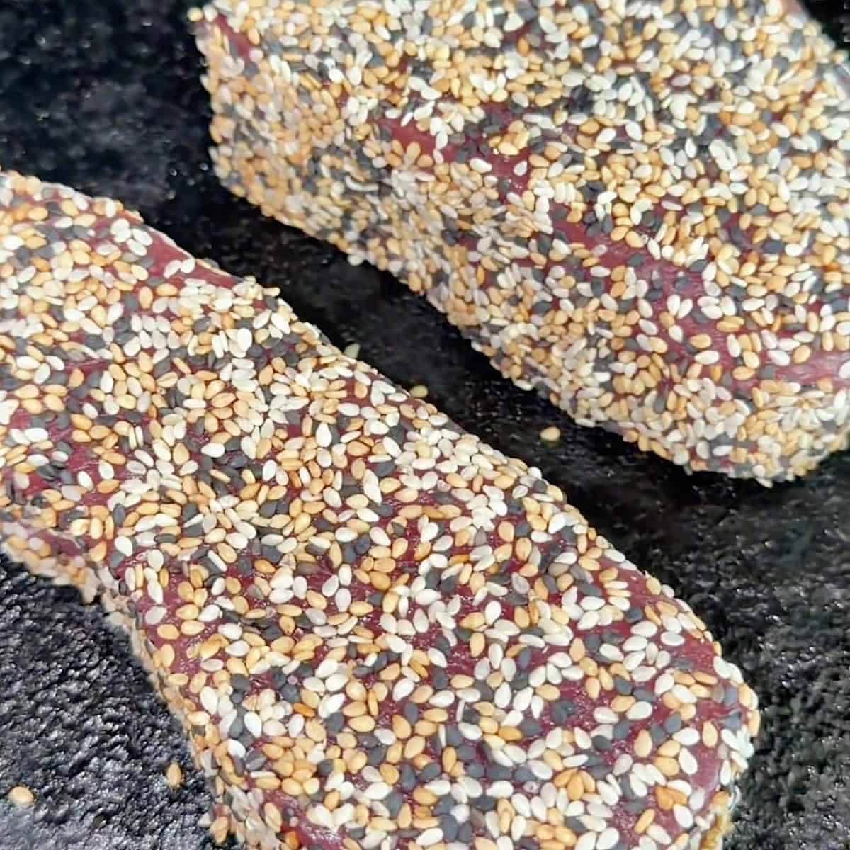 Searing the sesame crusted ahi tuna in a cast iron skillet.
