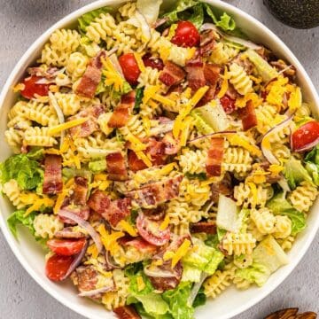 BLT pasta salad tossed in a wide serving bowl.