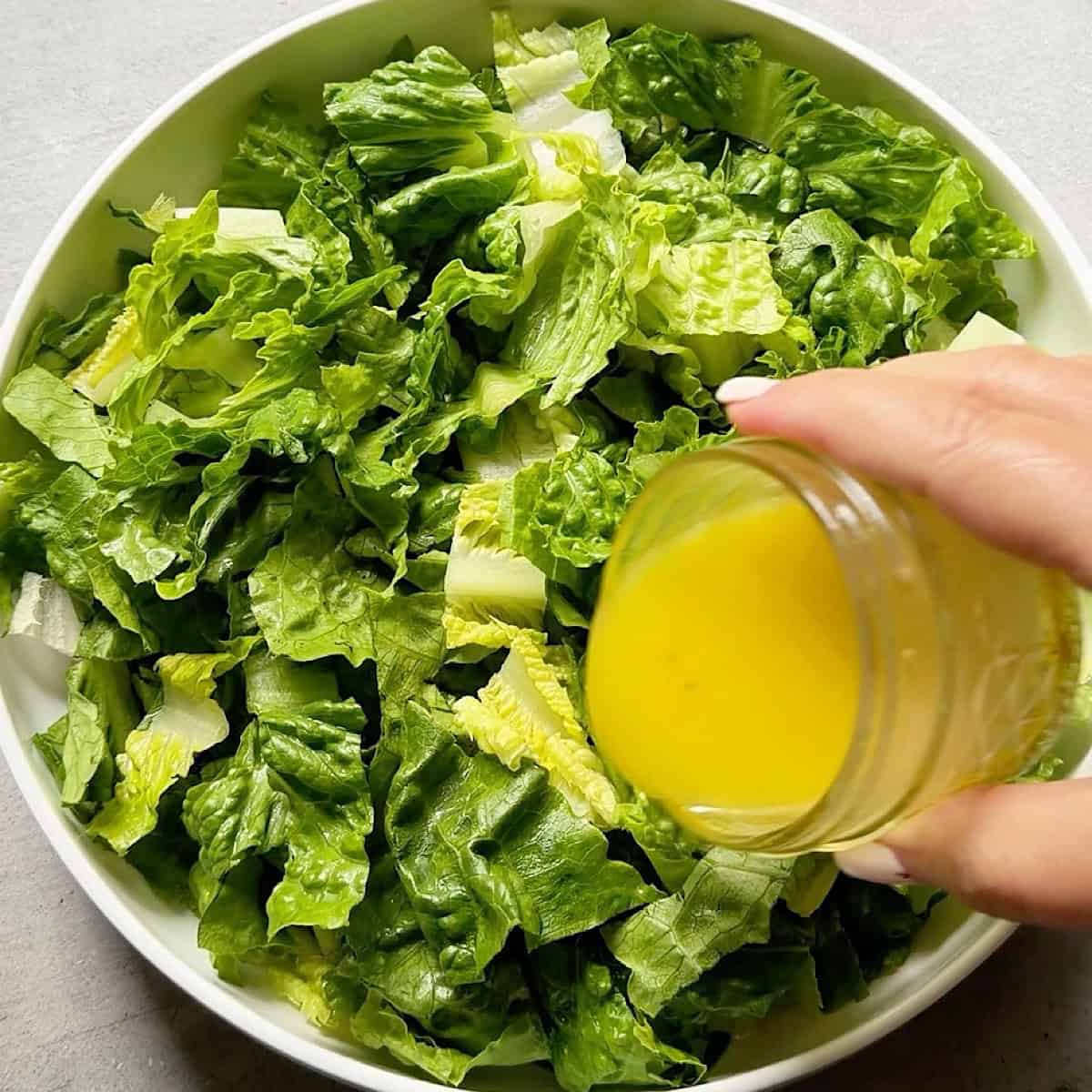 Dressing the romaine lettuce.