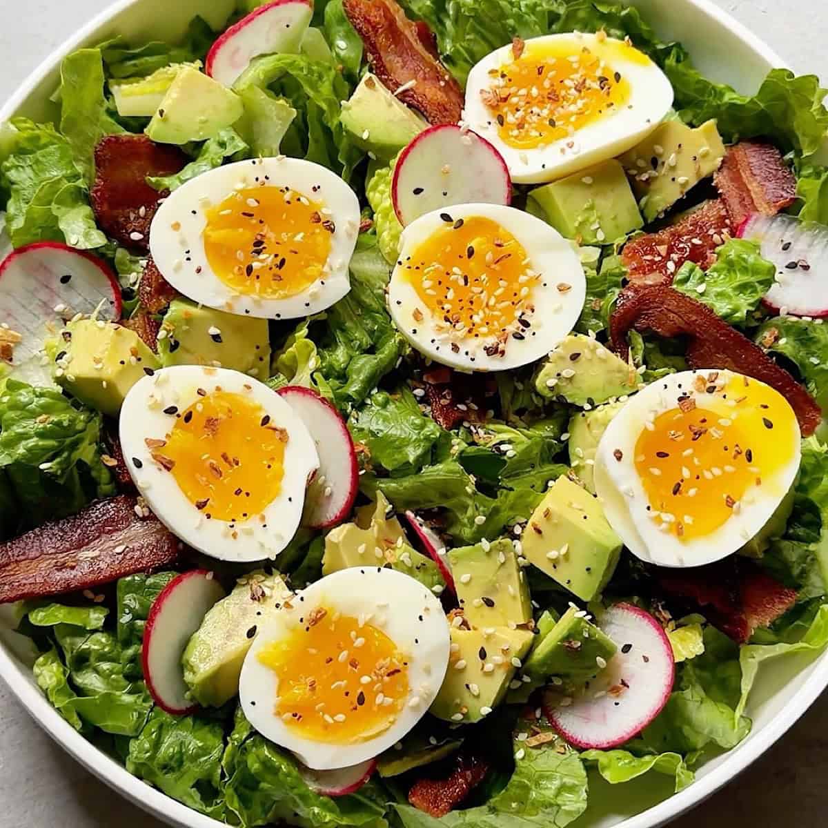 Assembled breakfast salad with Everything bagel seasoning.