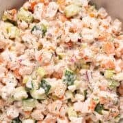 Creamy cucumber shrimp salad in a white bowl.