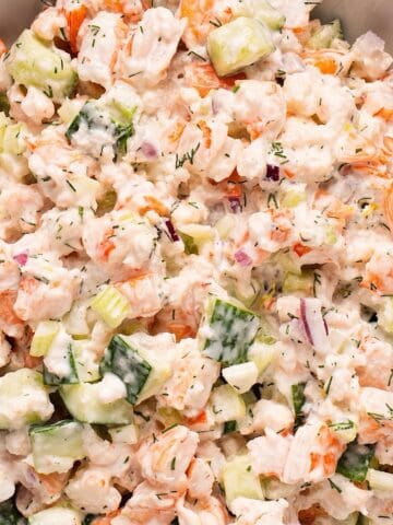 Creamy cucumber shrimp salad in a white bowl.