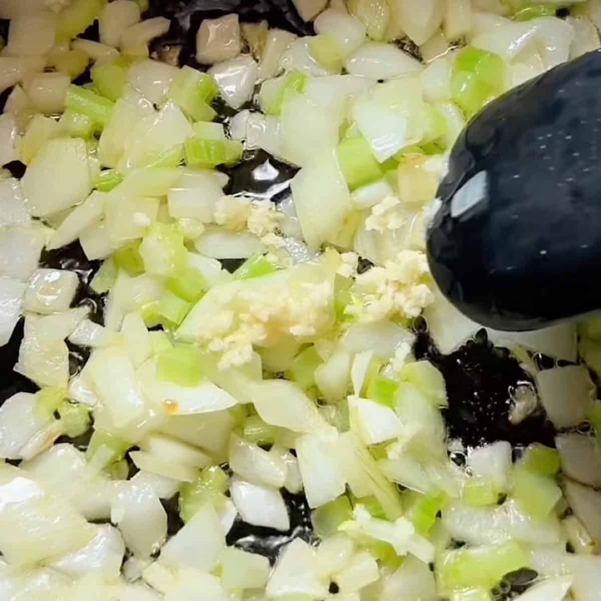 Sauteeing the aromatics with garlic.