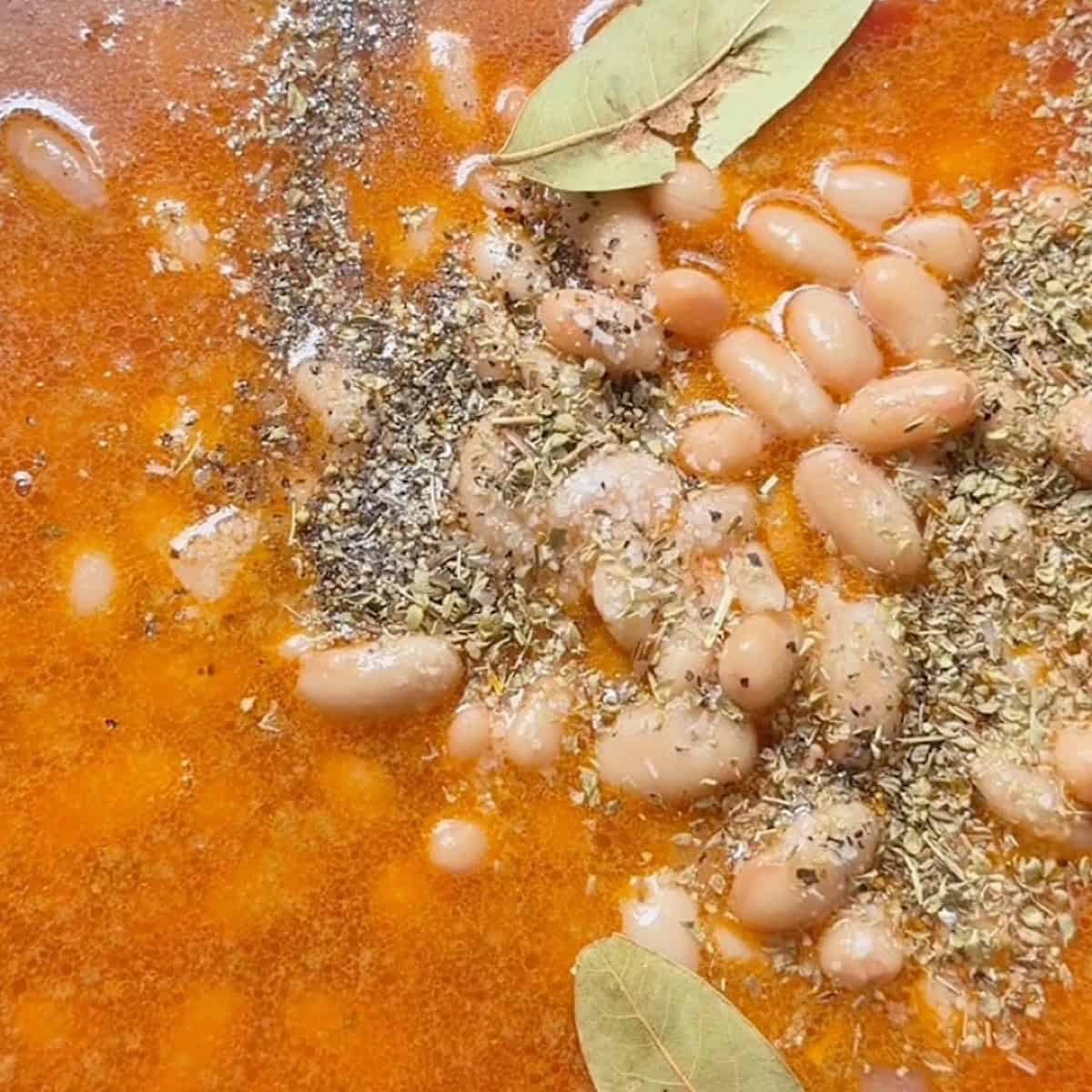 Building the soup with vegetable broth, diced tomatoes, and seasonings.