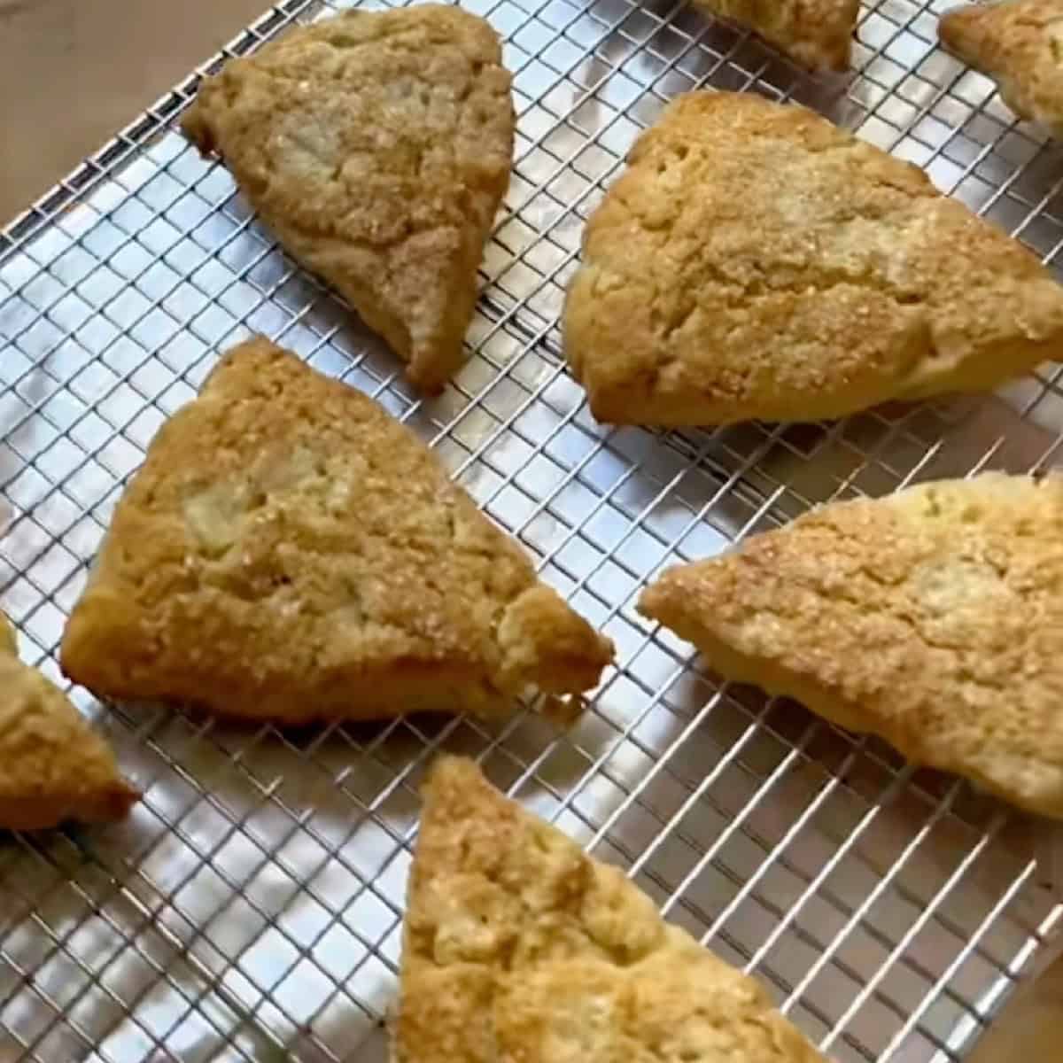 Baked scones on a wire rack ready to be glazed.