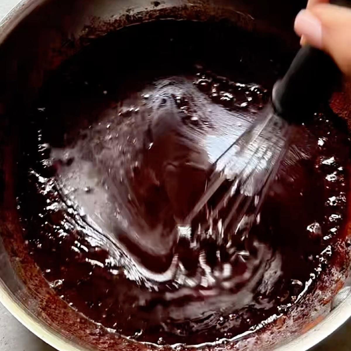 Whisking the warm chocolate honey coating.