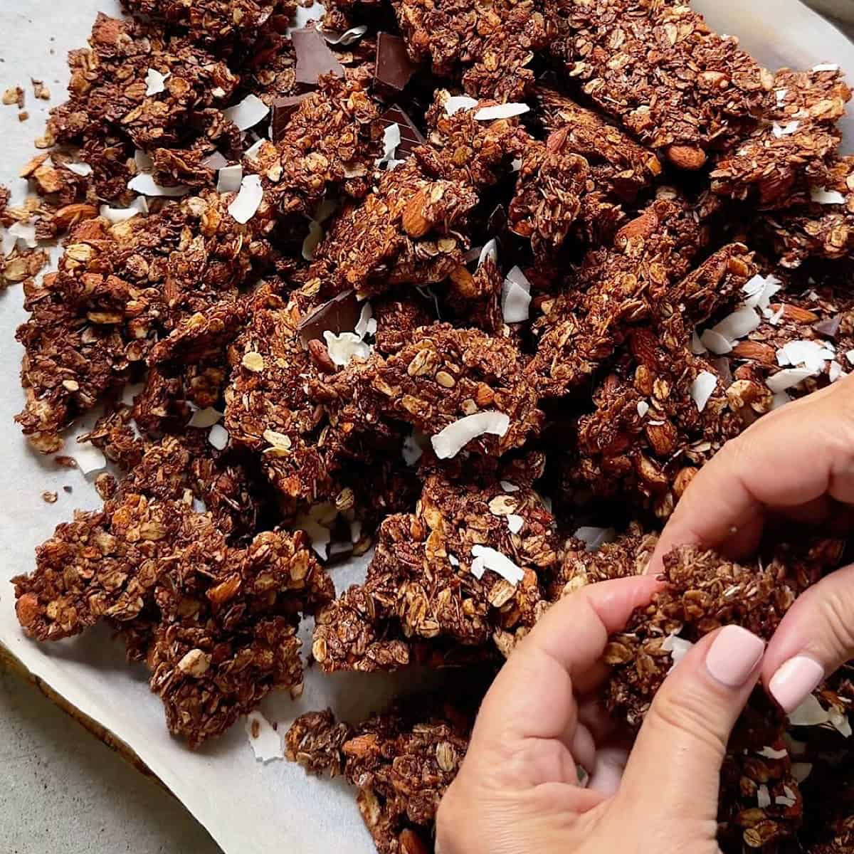 Breaking up the dark chocolate granola clusters.