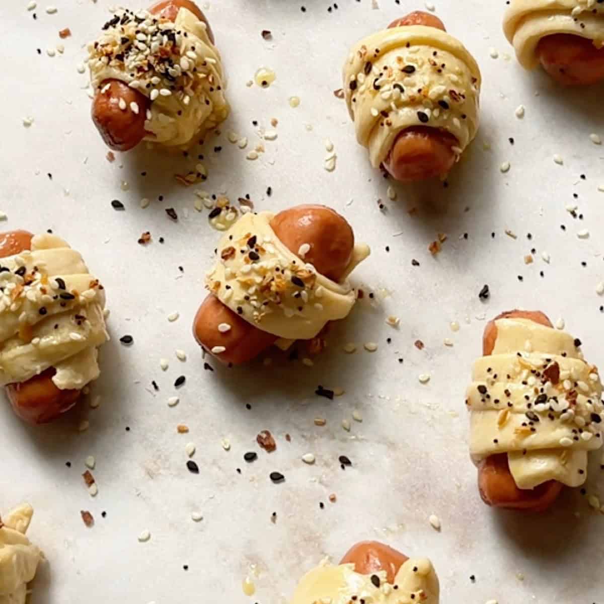 Pigs in a blanket with eggwash and everything bagel seasoning ready to bake.