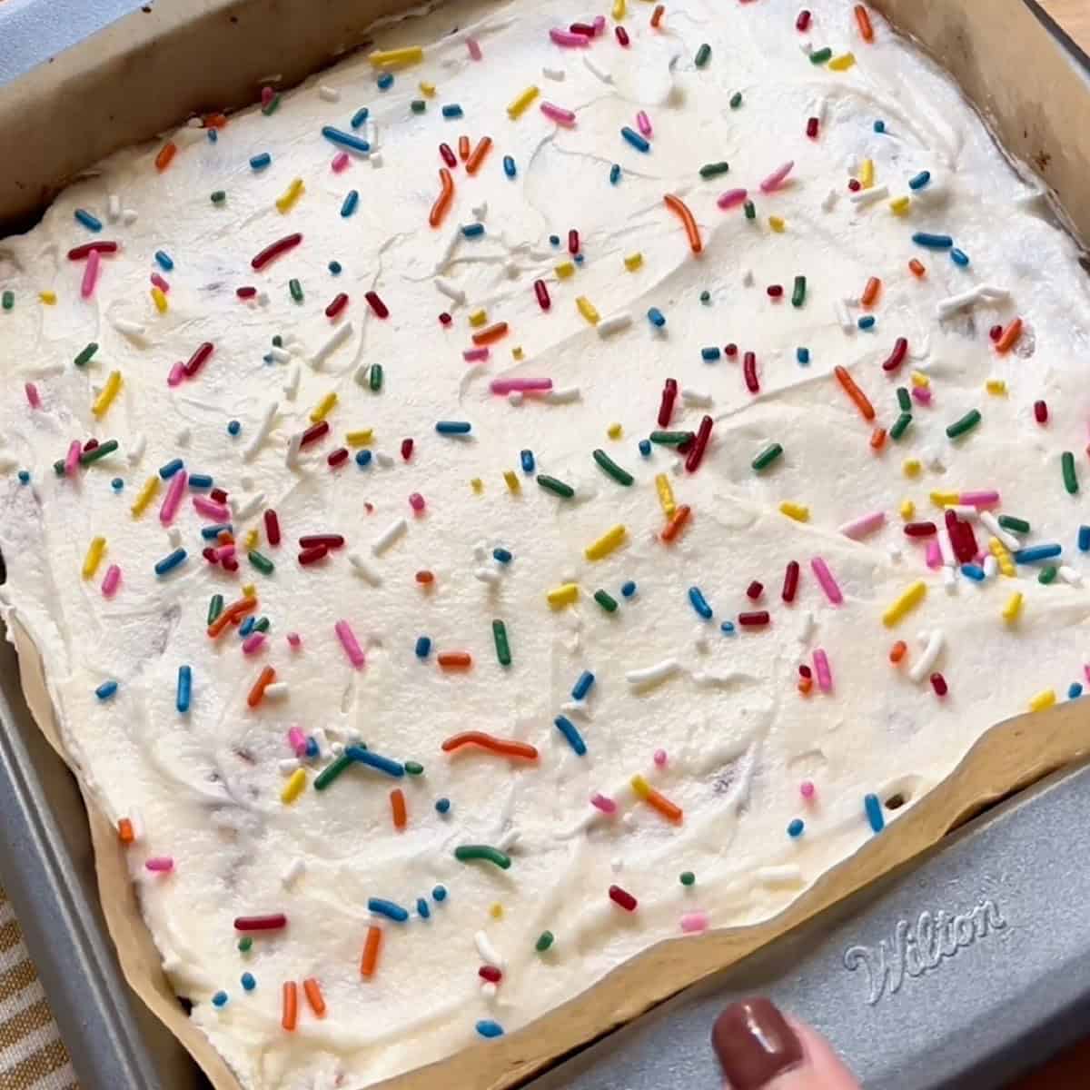 Frosted funfetti blondies baked and ready to slice for serving.