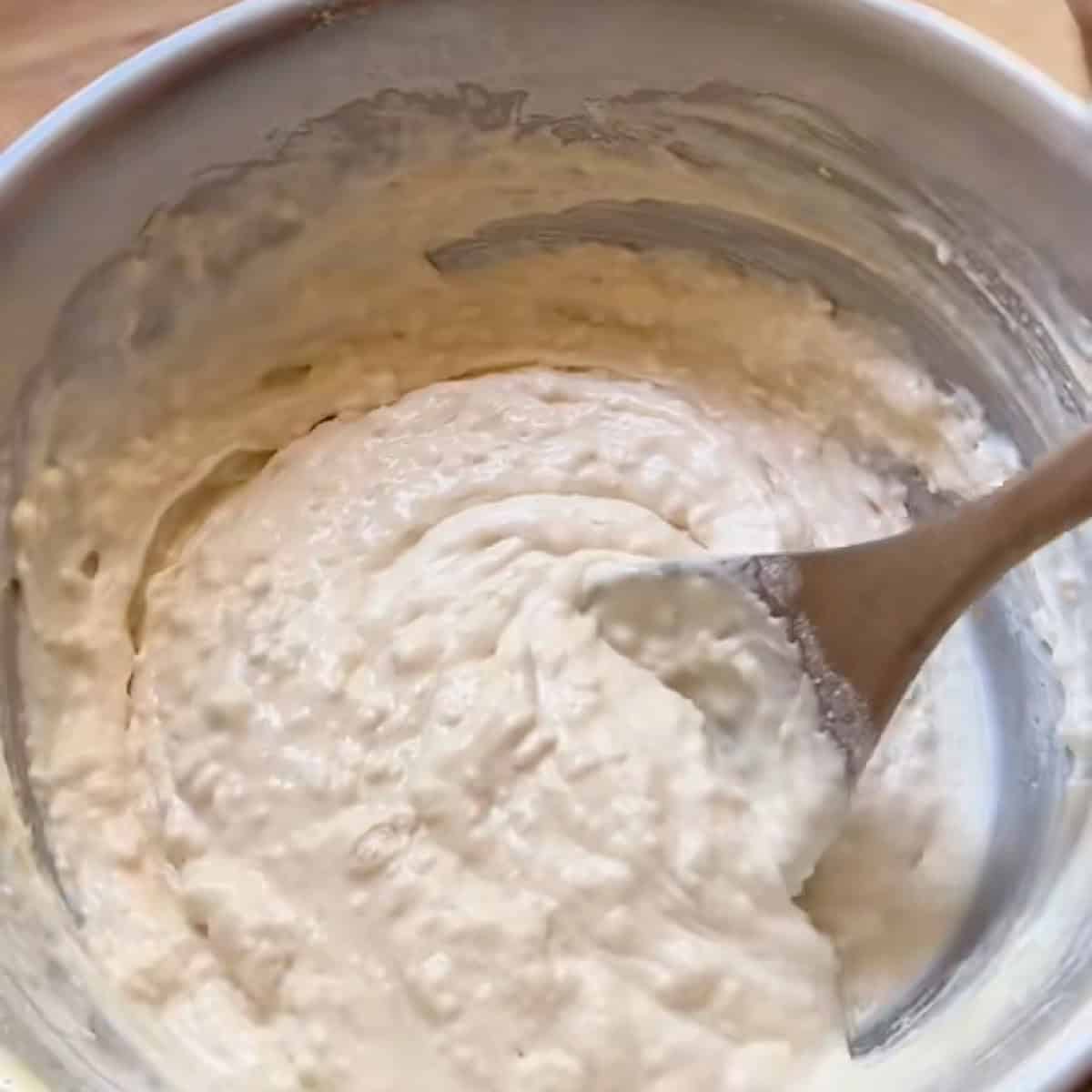 Mixing spoon in a bowl of belgian waffle batter.