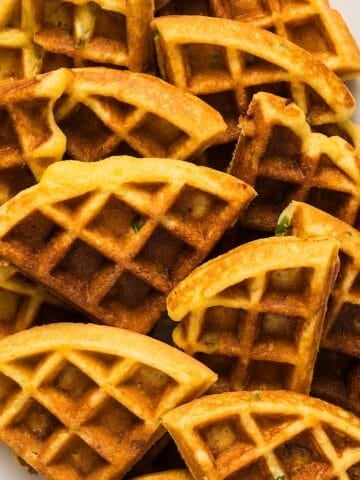 Bacon Jalapeno Cornbread Waffles wedges on a platter with a silver fork.