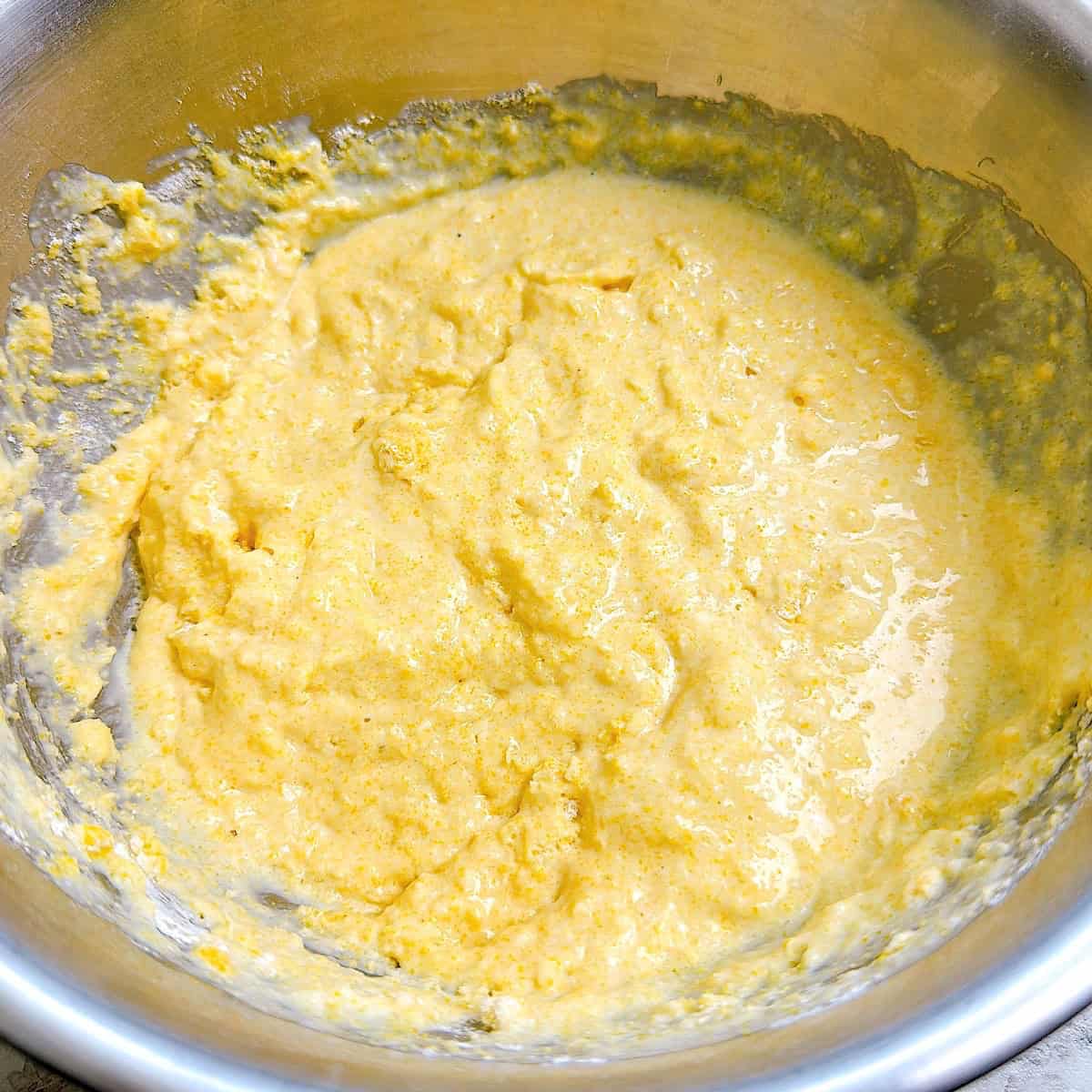 Wet cornmeal batter mixed in a mixing bowl.