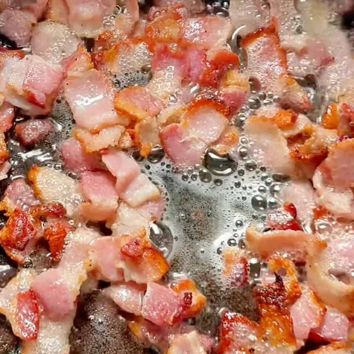 Crisping the chopped bacon.