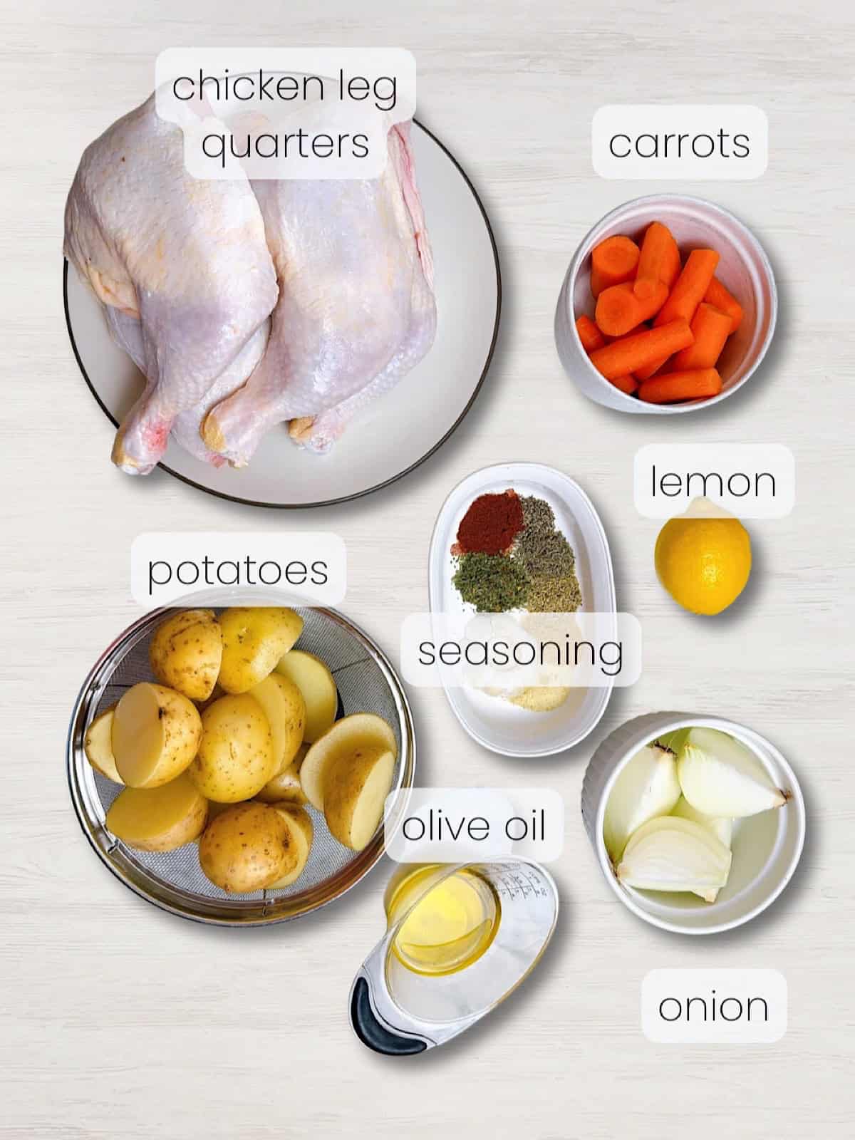 A labeled image of everything needed to make herb roasted chicken with carrots and potatoes.