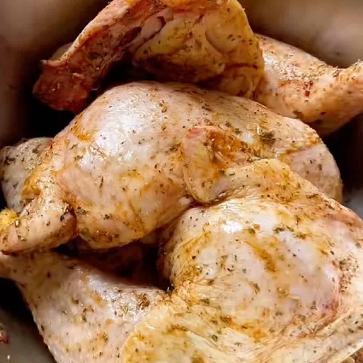 Chicken leg quarters with seasoning.