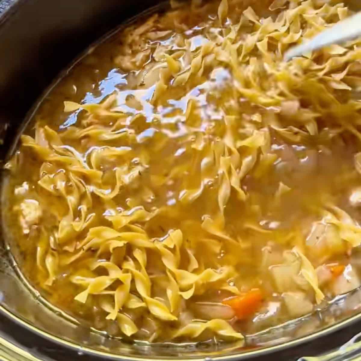 Leftover turkey noodle soup with cooked egg noodles.