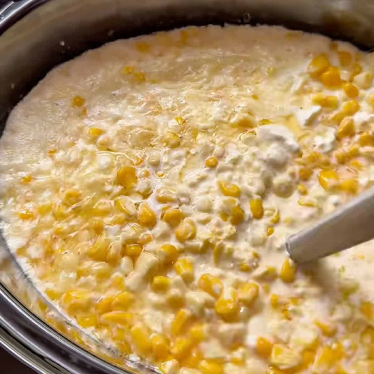 Immersion blender in slow cooker to improve the texture of the creamed corn.