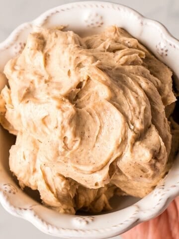 Holding fluffy whipped brown sugar cinnamon butter in a decorative bowl.