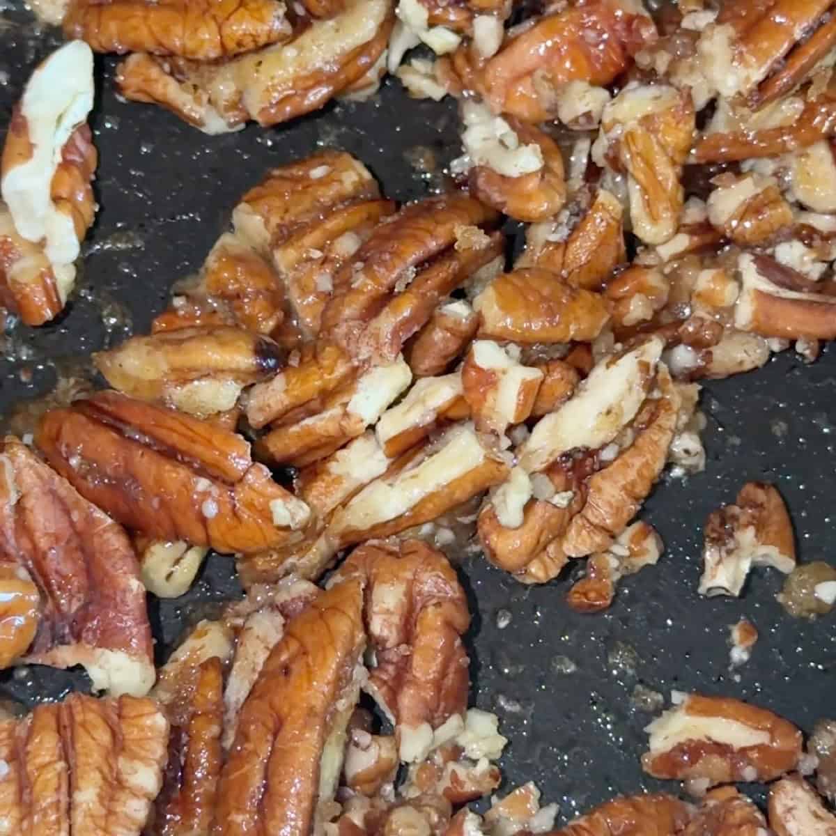 Toasting the pecan pieces in a skillet
