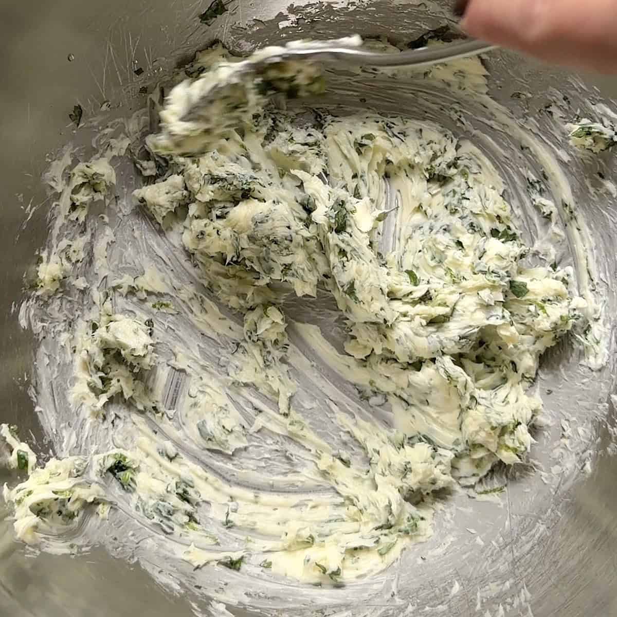 Mixing the butter with the cilantro lime juice and zest.