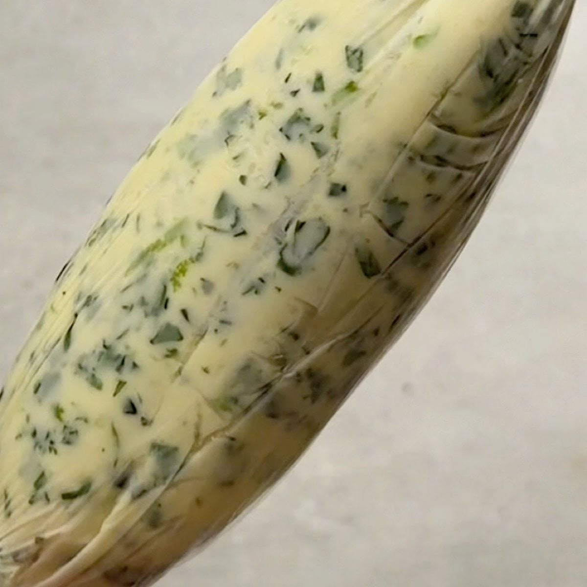 Cilantro lime compound butter rolled up into a log.