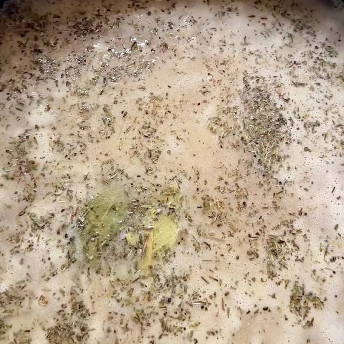 Wild rice soup simmering with herbs.