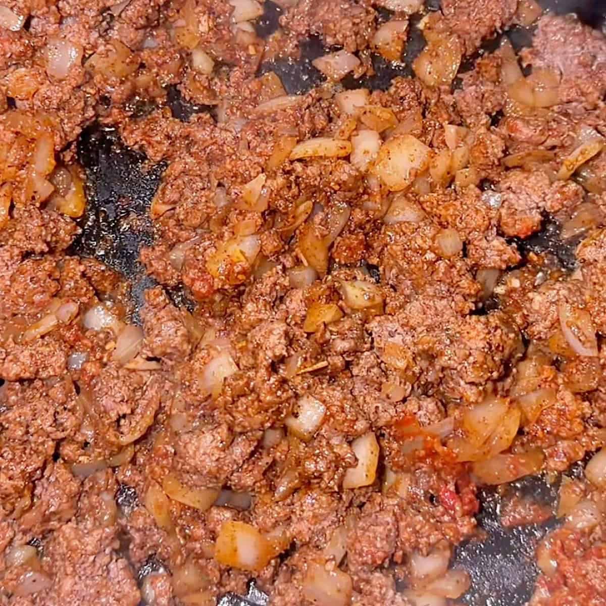 Browned beef with tomato paste and taco seasoning.